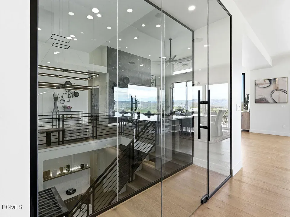 Glass-walled stairwell atrium with mountain views beyond