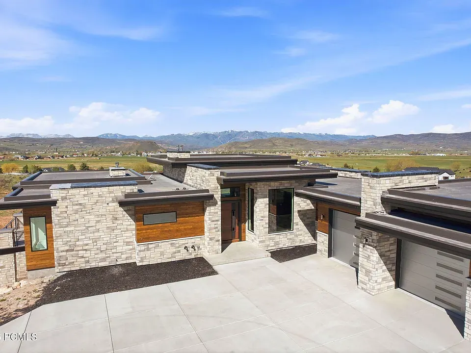 Modern stone and timber single-level home with panoramic Wasatch views